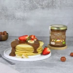 Organic hazelnut and chocolate spread on pancakes